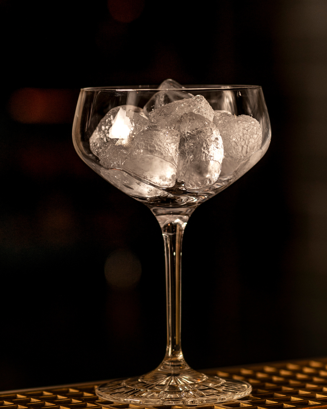 An empty cocktail glass with ice 