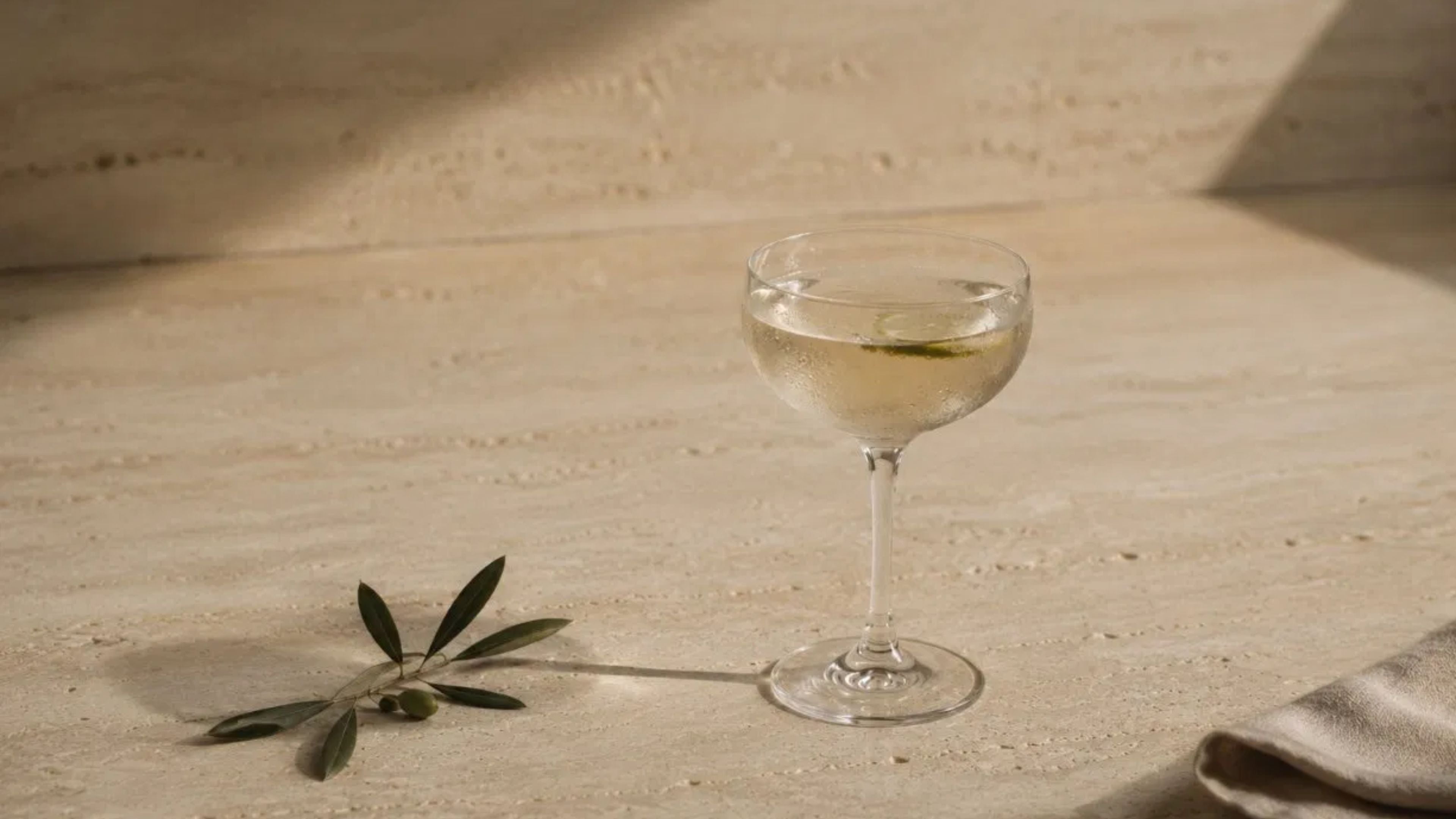 non alcoholic martini cocktail with olive branch curated by RIENNE