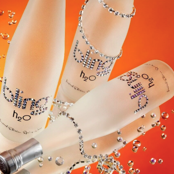 Bottle of Bling h2o with rhinestone embellishments on an orange background