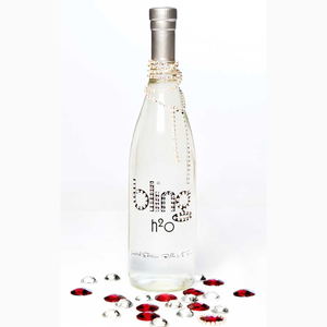 Decorative water bottle with rhinestone embellishments on a white background