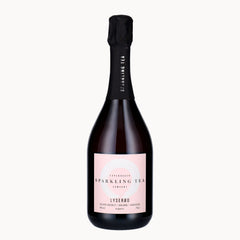 A bottle of Lyserød Copenhagen Sparkling Tea Company sparkling tea, featuring a pale pink label and a black foil-wrapped neck, set against a solid off-white background.