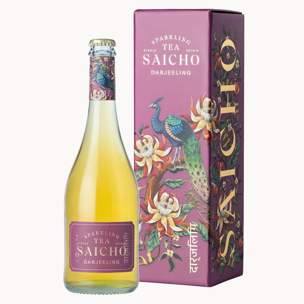 A bottle of Saicho Darjeeling sparkling tea next to its illustrated purple packaging box, featuring peacock and floral designs on a light gray background.