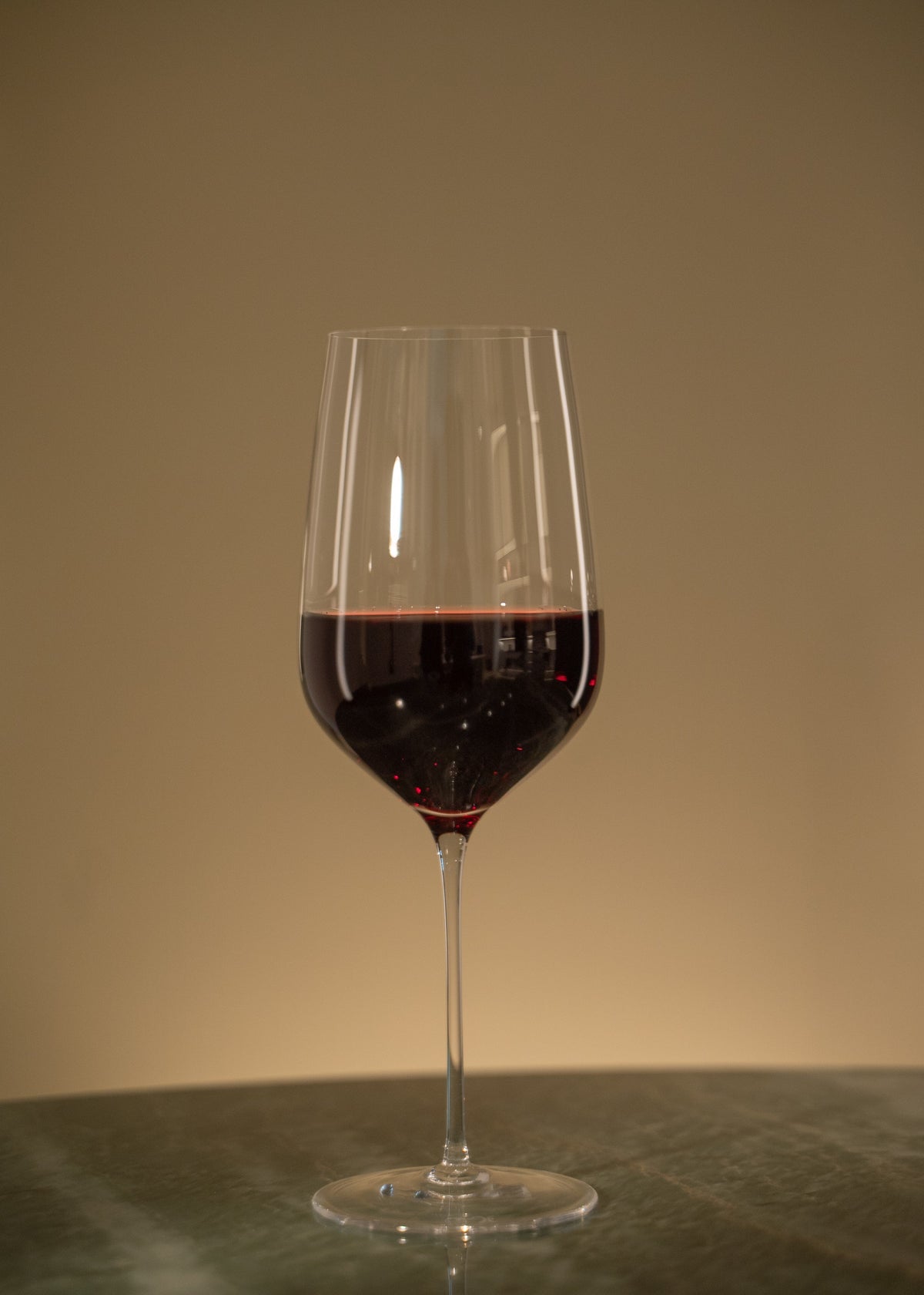 Glass of red zero proof wine at RIENNE
