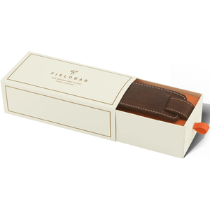 Open box displaying a brown leather item with 'Fieldbar' branding on a white background