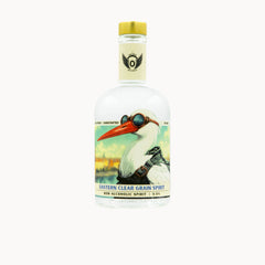 A clear glass bottle of Eastern Clear Grain Spirit non-alcoholic spirit, featuring a vintage-style label with an illustration of a white bird wearing goggles and a yellow cap, on a light gray background.
