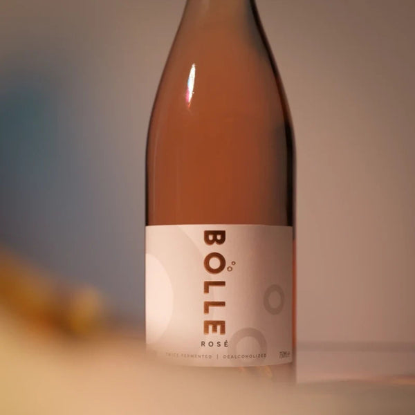 Close-up of the BOLLE Rosé label at RIENNE in soft warm light, twice-fermented dealcoholized non-alcoholic wine