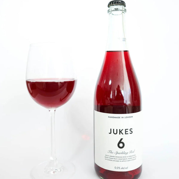 JUKES 6 The Sparkling Red bottle and filled wine glass at RIENNE, non-alcoholic wine alternative, 0.0% alc/vol