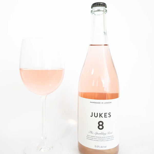 JUKES 8 The Sparkling Rosé bottle and filled wine glass at RIENNE, non-alcoholic wine alternative, 0.0% alc/vol