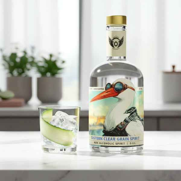 RIENNE Volante Vodka bottle on a marble counter beside a zero-proof cucumber soda over ice